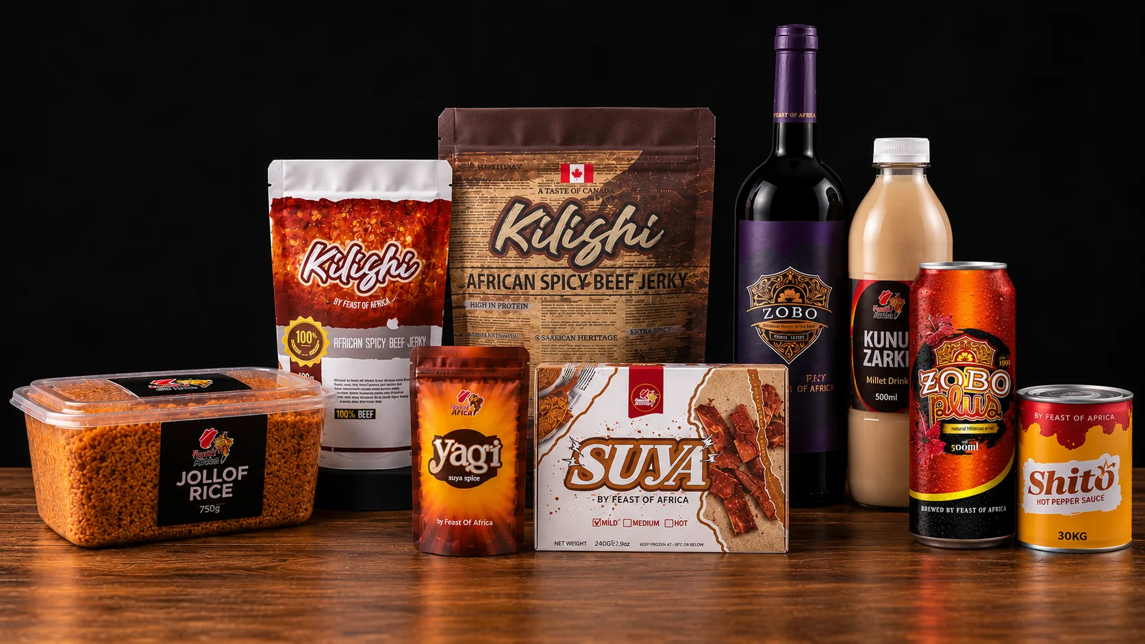 The five Feast of Africa brands staged together on a wooden table: suya spice, boxed suya, bottled zobo, kunu zaki, jollof rice and shito